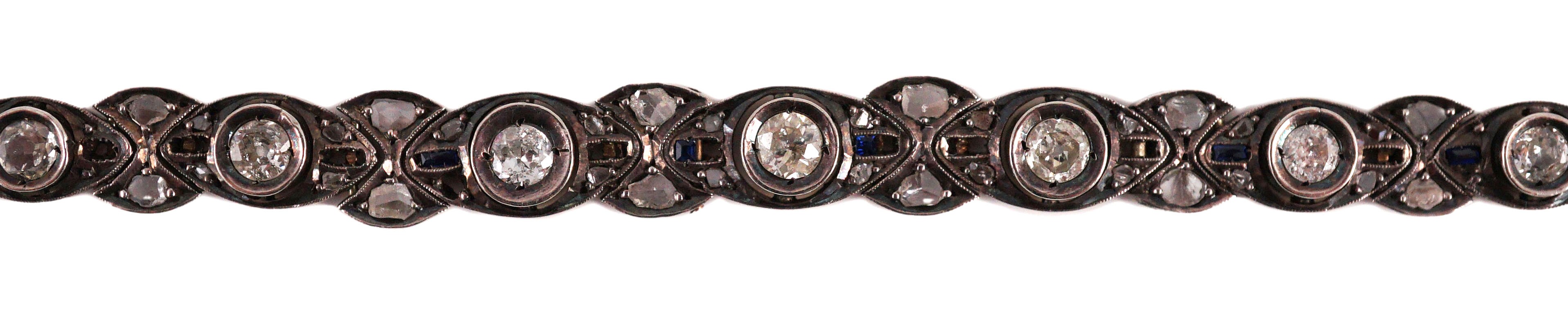 An early to mid 20th century continental gold and silver, graduated diamond and sapphire set line bracelet